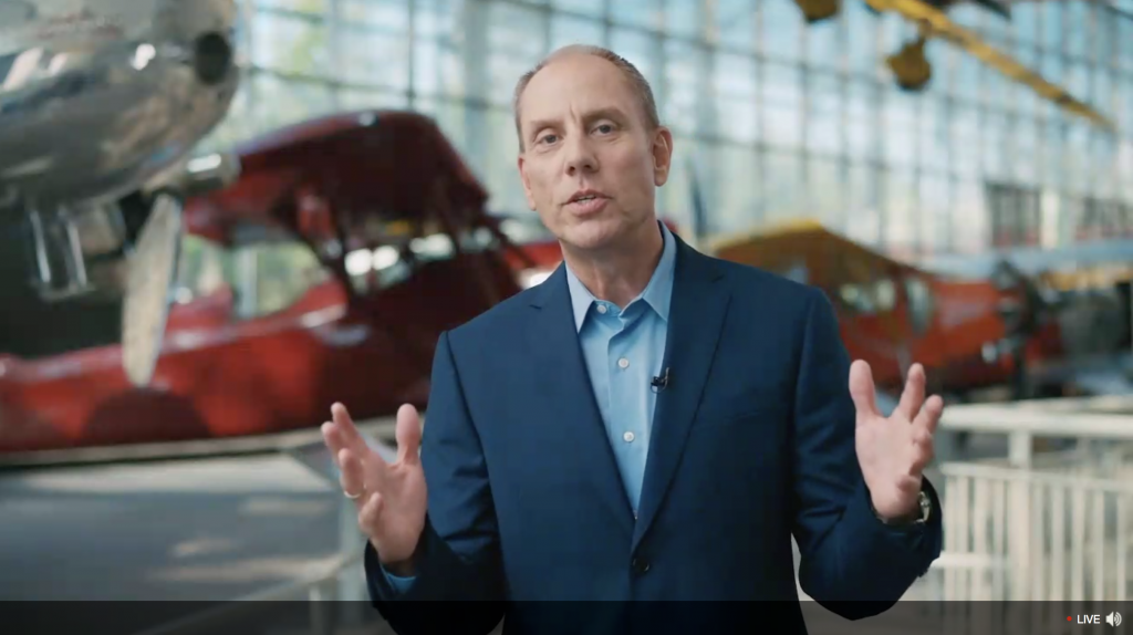 Image in acu-connect blog of Jon Roskill, Acumatica CEO, in an airplane museum for the Acumatica 2020 R2 Virtual Launch Event.